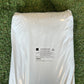 Un sac blanc de produit "Top Dressing Park" posé sur une pelouse. L'étiquette imprimée au centre indique la composition : compost vert, écorce compostée, tourbe blonde, céramique poreuse et sable, avec un enrichissement en algues et engrais organominéral.